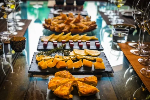 Band performing traditional fado music beneath a pergola decorated with classic Portuguese azulejos in Lisbon, Portugal.