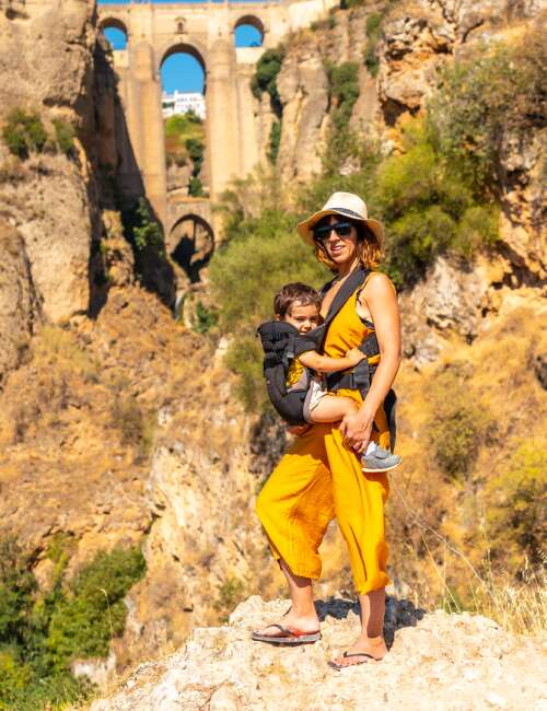 A woman carrying her son on a hike to the new bridge viewpoint in Ronda, the province of Malaga, Andalucia, in Spain.
