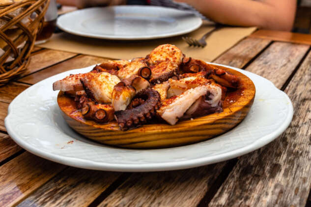 Galician Galician-style octopus in a restaurant. Octopus with paprika, potatoes, and olive oil.