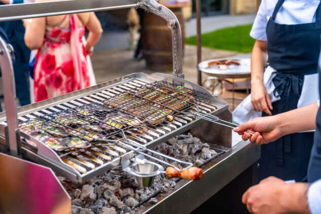 cooking Locals cooking grilled fish on an outdoor barbecue.