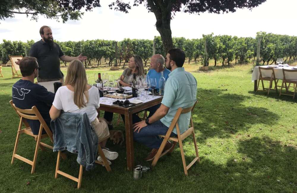 A group of people sitting at a table at a La Rioja private hidden chateaux in Spain.