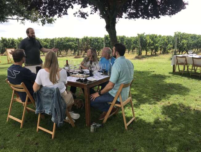 A group of people sitting at a table at a La Rioja private hidden chateaux in Spain.