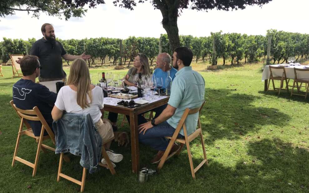 A group of people sitting at a table at a La Rioja private hidden chateaux in Spain.