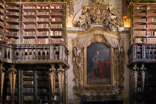 explore purtugal Interior of Biblioteca Joanina at the University of Coimbra, Portugal, featuring ornate wooden bookshelves, historic decor, and the grand design of one of Europe’s oldest university libraries.