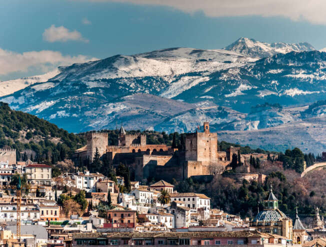 Winter view of the famous Alhambra in front of Sierra Nevada, Spain.