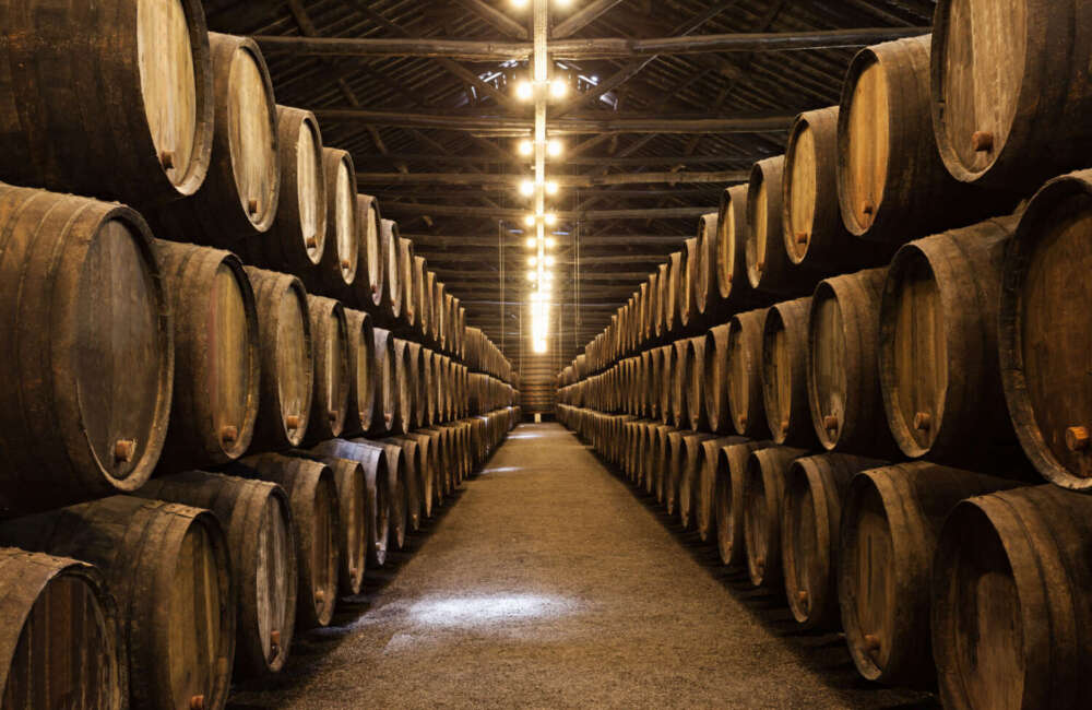 Wine barrels in the wine cellar at a winery in Porto, Portugal.