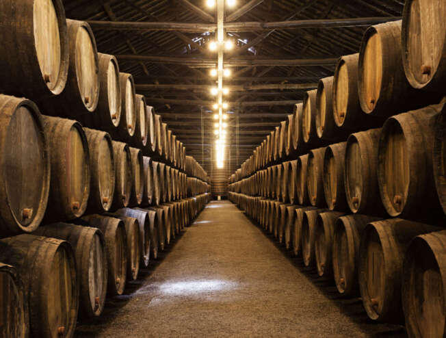 Wine barrels in the wine cellar at a winery in Porto, Portugal.