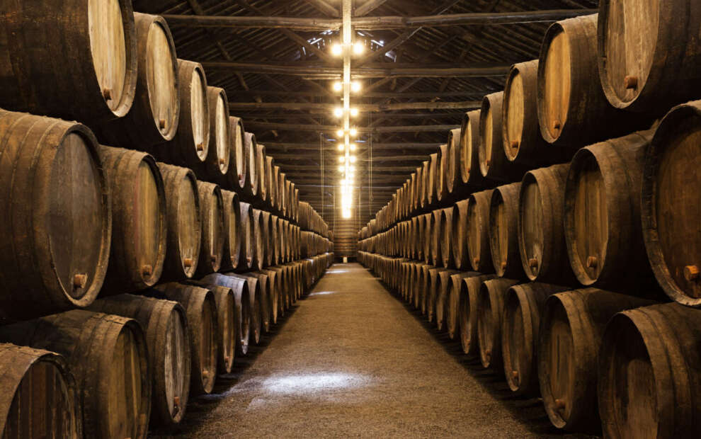 Wine barrels in the wine cellar at a winery in Porto, Portugal.