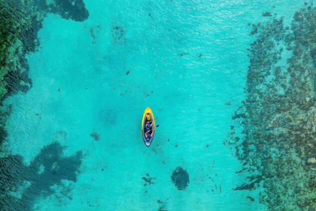 Aerial,View,Of,Yellow,Kayak,In,Blue,Lagoon,At,Summer.