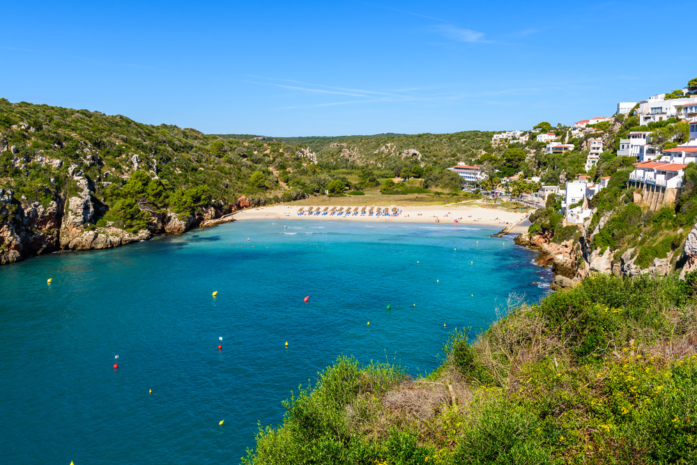 Aerial view of Cala En Porter Beach, one of the best resort beaches in Menorca, Spain.