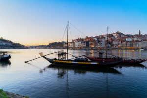 Picturesque, colorful view of the old town of Porto at sunset over the Douro River.